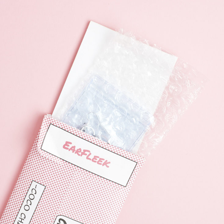 EarFleek envelope with items popping out