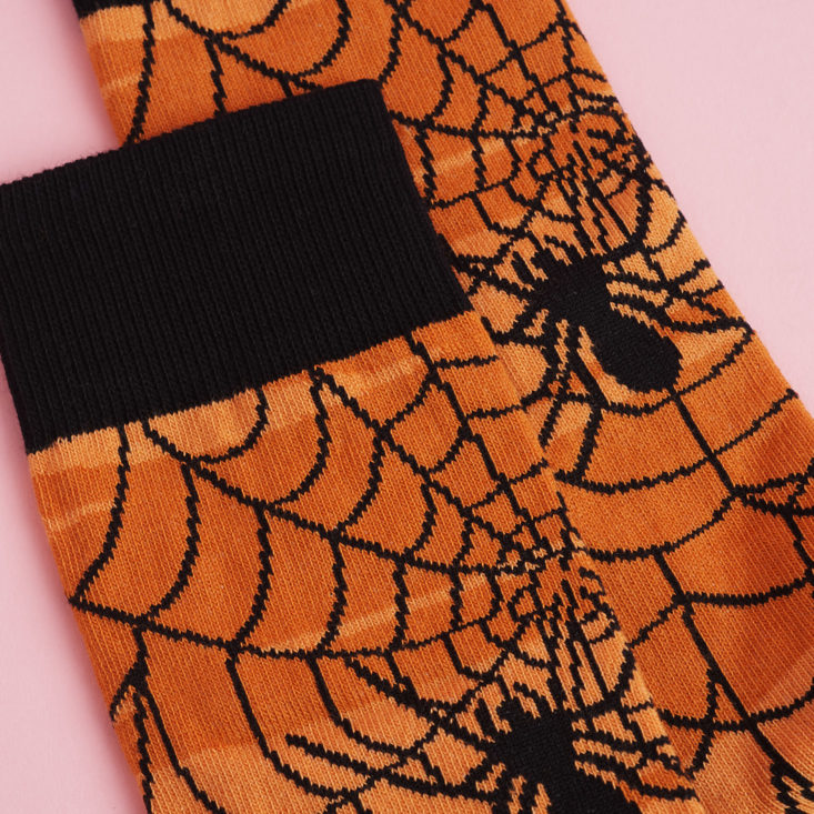 detail of orange and black spider web socks