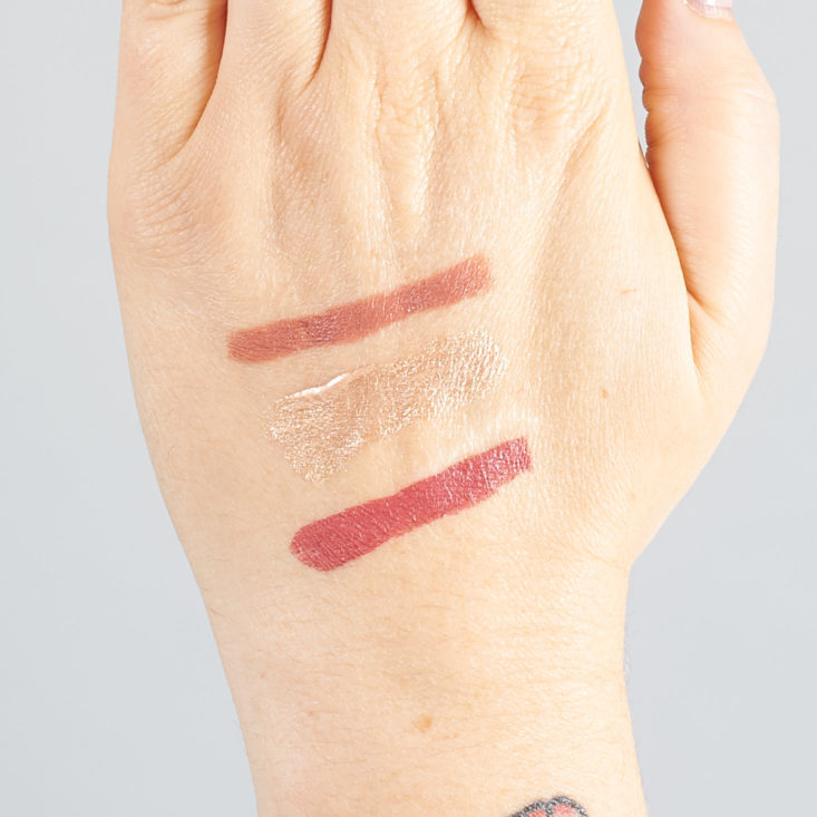Swatches for multistick, luminizer, and lipstick on Marne's hand