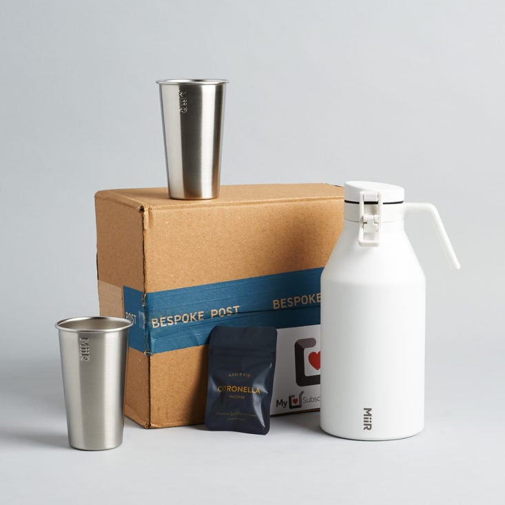 Insulated growler, 2 stainless steel cups, and incense cones around Bespoke Box