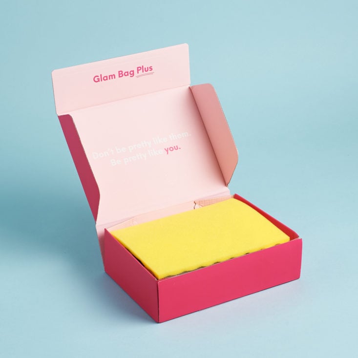 open pink box with yellow tissue inside