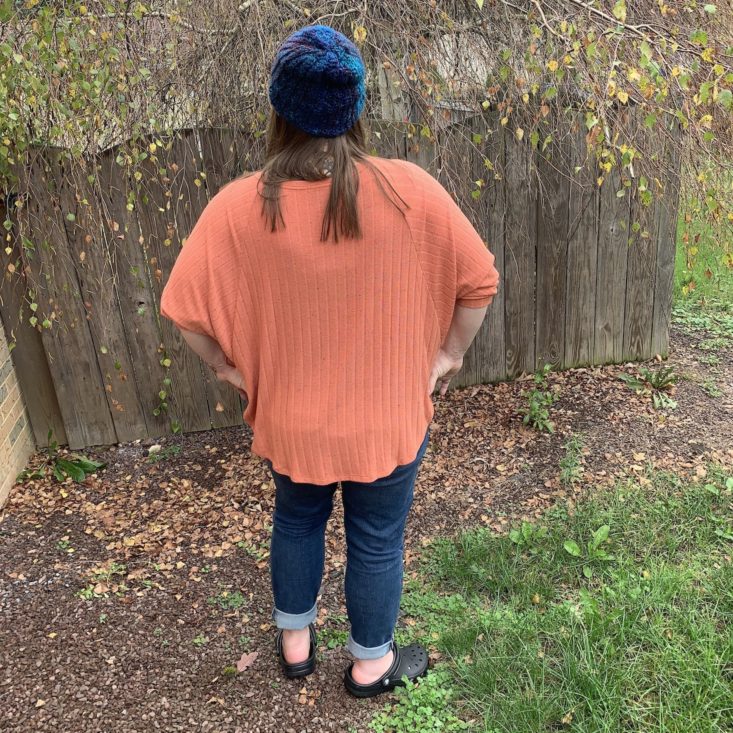 back view of the styled orange sweater