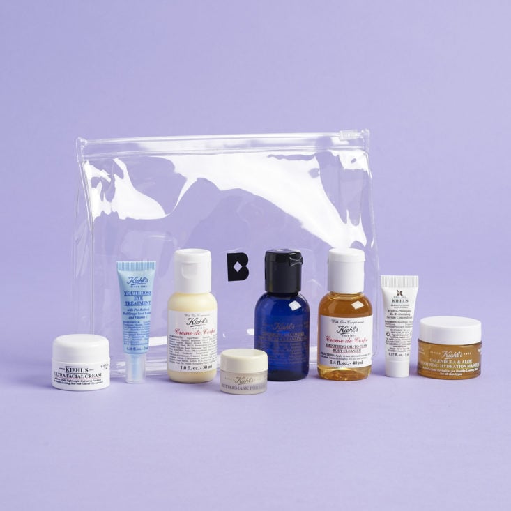 items from Birchbox x Kiehl's On The Go Kit in front of clear pouch